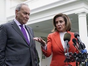FILE - Senate Majority Leader Chuck Schumer of N.Y., right, listens as House Speaker Nancy Pelosi of Calif., left, speaks to reporters at the White House in Washington, Nov. 29, 2022, about their meeting with President Joe Biden. Congress is moving swiftly to prevent a looming U.S. rail workers strike. Lawmakers are reluctantly intervening in a labor dispute to stop what would surely be a devastating blow to the nation's economy if the transportation of fuel, food and other critical goods was disrupted