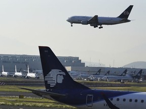 FILE - Passenger planes land at Benito Juárez International Airport in Mexico City, May 12, 2022.