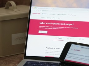 A computer and phone display pages from Medibank Private in Sydney, Tuesday, Nov. 8, 2022. Health insurer Medibank on Monday ruled out paying ransom for stolen customer data while a purported hacker responded on Tuesday by setting a 24-hour deadline for the release that data including personal medical histories.