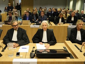 Peter Langstraat, left, along with other lawyers of the victims sit in court before the verdict session of the Malaysia Airlines Flight 17 trial at the high security court at Schiphol airport, near Amsterdam, Netherlands, Thursday, Nov. 17, 2022. The Hague District Court, sitting at a high-security courtroom at Schiphol Airport, is passing judgment on three Russians and a Ukrainian charged in the downing of Malaysia Airlines flight MH17 over Ukraine and the deaths of all 298 passengers and crew on board, against a backdrop of global geopolitical upheaval caused by Russia's full-blown invasion of Ukraine in February and the nearly nine-month war it triggered.