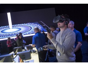 An attendee during Apple's Worldwide Developer Conference (WWDC) in San Jose, California, on Monday, June 5, 2017, showed off an HTC Corp. virtual reality headset.  Vive (VR) wearers are turning their passions into future innovations and apps that customers use every day across iPhone, iPad, Apple Watch, Apple TV and Mac.