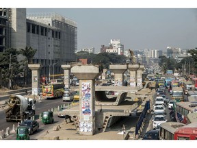 Traffic travels past an under construction elevated line for the Dhaka Mass Rapid Transit Co. metro in Dhaka, Bangladesh, on Tuesday, Dec. 10, 2019. Bangladesh estimated 8.15% GDP growth for the year that ended June 30.