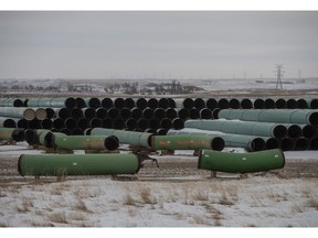 Pipes for the Keystone XL pipeline stacked in a yard near Oyen, Alberta, Canada, on Tuesday, Jan. 26, 2021. U.S. President Joe Biden revoked the permit for TC Energy Corp.'s Keystone XL energy pipeline via executive order hours after his inauguration, the clearest sign yet that constructing a major new pipeline in the U.S. has become an impossible task.