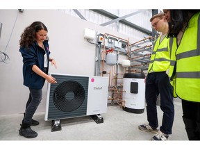 A trainer shows trainees a newly installed heat pump system at the Octopus Energy Ltd.'s training and R&D centre in Slough, U.K., on Tuesday, Sept. 28, 2021. Octopus, backed by Al Gore's sustainability fund, is helping teach the plumbers to install heat pumps that will play a pivotal role in the U.K.'s strategy to have net-zero emissions by 2050.