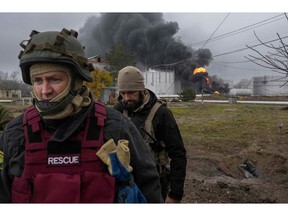 Inspections after an attack on an oil reserve in Kherson. Photographer: Bulent Kilic/AFP/Getty Images