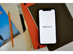 The VMware logo on a smartphone arranged in the Brooklyn borough of New York, US, on Monday, May 23, 2022. Broadcom Inc. is in talks to acquire VMware Inc., the cloud-computing company backed by billionaire Michael Dell, setting up a blockbuster tech deal that would vault the chipmaker into a highly specialized area of software. Photographer: Gabby Jones/Bloomberg