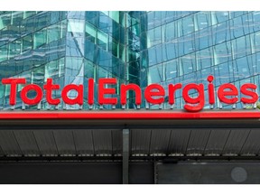 Signage for TotalEnergies SE at the company's electric vehicle charging station in the La Defense business district in Paris, France, on Thursday, July 28, 2021. TotalEnergies will extend its $2 billion buyback program into the third quarter after profit surged to a record, propelled by surging gasoline prices and soaring demand for natural gas in Europe. Photographer: Benjamin Girette/Bloomberg