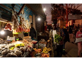 Bulbs illuminate a food stall in the Imizamo Yethu informal settlement in the Hout Bay district of Cape Town, South Africa, on Wednesday, Aug. 3, 2022. South Africa's state-owned power utility Eskom Holdings SOC Ltd. warned it may have to implement rolling blackouts for the first time in more than a week due to a shortage of generation capacity.