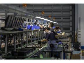 Employees on an assembly line for refurbished computer consoles at the Sketch Global facility in the Lingang Special Area and Comprehensive Zone in Shanghai, China, on Thursday, Aug. 25, 2022. Lingang, a 120-square-kilometer (46 -square-mile) patch of land southeast of Shanghai roughly a sixth the size of Singapore, was designated by Chinese President Xi Jinping in 2018 as the country's top free-trade area, to be modeled after the likes of Singapore and Dubai. Photographer: Qilai Shen/Bloomberg