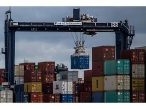 A gantry crane lifts a container on the dockside during the first day of the second-round of strike action by Unite union members and dockworkers at the Port of Felixstowe in Felixstowe, UK, on Tuesday, Sept. 27, 2022. Dock workers at Felixstowe, Britain's largest container port, rejected a pay deal imposed by management, that paved the way for this new round of industrial action and disruption to vital trade flows. Photographer: Chris J. Ratcliffe/Bloomberg