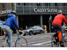 Commuters cycle past a Credit Suisse Group AG bank branch in Basel, Switzerland, on Tuesday, Oct. 25, 2022. Credit Suisse will present its third quarter earnings and strategy review on Oct. 27. Photographer: Stefan Wermuth/Bloomberg