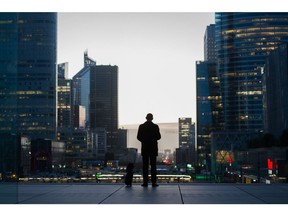 An office worker at sunrise in the La Defense financial district in Paris, France, on Wednesday, Nov. 2, 2022. In October, the Bank of France said the economic downturn implied in the bottom of its forecast range would only be "limited and temporary."