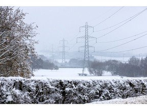 Electricity pylons in snow-covered fields near London in December 2022. Photographer: Chris Ratcliffe/Bloomberg