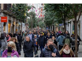 Shoppers make their way along the Calle de Fuencarral retail street in Madrid, Spain, on Thursday, Dec. 29, 2022. The euro area faces a "very difficult economic situation" that will test individuals and businesses, European Central Bank Vice President Luis de Guindos said.