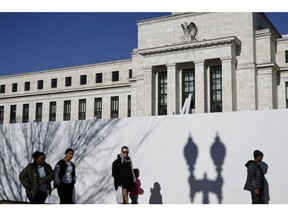 Pedestrians near the Marriner S. Eccles Federal Reserve building in Washington, DC, US, on Friday, Dec. 30, 2022. The Federal Reserve's preferred inflation measures eased in November while consumer spending stagnated, suggesting the central bank's interest-rate hikes are helping to cool both price pressures and broader demand, with more tightening on the way. Photographer: Ting Shen/Bloomberg