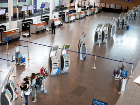 Travellers check in at an airport