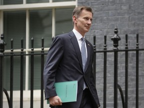 FILE - Britain's Treasury Chief Jeremy Hunt leaves 11 Downing Street on Nov. 17, 2022. Britain is easing banking rules brought in after the 2008 global financial crisis in a bid to attract investment and secure London's status as Europe's leading finance center. Hunt said Friday, Dec. 9, 2022, that the changes, which follow Britain's departure from the European Union in 2020, will make Britain "one of the most open, dynamic and competitive financial services hubs in the world."