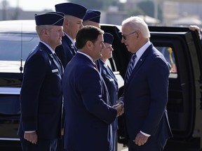 President Joe Biden greets Arizona Gov. Doug Ducey after arriving on Air Force One, Tuesday, Dec. 6, 2022, at Luke Air Force Base in Maricopa County, Ariz.