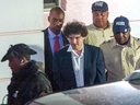  FTX founder Sam Bankman-Fried, centre, is led away handcuffed by officers of the Royal Bahamas Police Force in Nassau, Bahamas, on Dec. 13. 