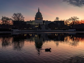 FILE - The sun rises behind the Capitol in Washington, early Wednesday, Dec. 14, 2022. Congressional leaders have unveiled a $1.7 trillion spending package early Tuesday, Dec. 20, 2022, that includes another large round of aid to Ukraine, a nearly 10% boost in defense spending and roughly $40 billon to assist communities across the country recovering from drought, hurricanes and other natural disasters.