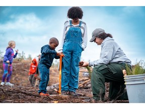 The community shows support for Hoke Community Forest by planting Longleaf seedlings on Saturday (12/3).
