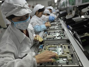 Chinese workers in the Foxconn factory which makes iPhones in Shenzhen, in southern China's Guangdong province.