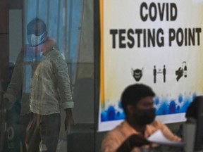 A passenger walks in to test for the COVID-19 coronavirus, on arrival at Anna International Airport in Chennai on Dec. 24, 2022.