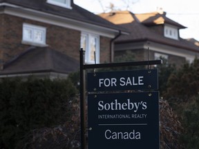 A real estate sale sign is shown in a west-end Toronto neighbourhood Saturday, March 7, 2020.&ampnbsp;The Toronto Regional Real Estate board says November home sales showed a similar retreat to recent months with activity down by about half from last year.