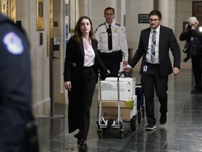 Documents arrive as the House Ways & Means Committee holds a hearing regarding tax returns from former President Donald Trump on Capitol Hill in Washington, Tuesday, Dec. 20, 2022.