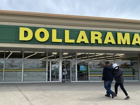 People walk into a Dollarama store in Toronto, Sept. 25, 2021.