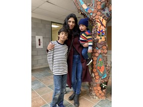 Misha, 40, poses with her kids Krishna, 9, and 15-month-old Surya, in Toronto, in a Thursday, Dec. 8, 2022, handout photo. It has been a challenging year financially for many Canadians grappling with decades-high inflation and soaring interest rates.