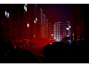 Light from homes within apartment blocks Pedestrians during a blackout in Kyiv, Ukraine, on Tuesday, Dec. 6, 2022. Ukrainians have been no strangers to hardship over the past century, but their dogged resilience and solidarity in the face of Russian bombardment has been an enduring image of a war that started at the tail end of last winter.