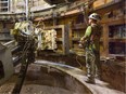 A construction worker "tubbing" a mine shaft at BHP Billiton Ltd.'s Jansen potash mine.