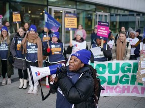 Members of the Royal College of Nursing (RCN) protest as nurses in England, Wales and Northern Ireland take industrial action over pay, outside the Queen Elizabeth Hospital in Birmingham, England, Tuesday, Dec. 20, 2022.