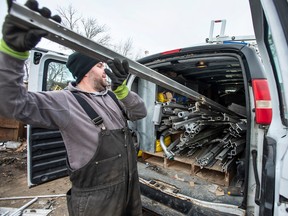 A person unloads scrap metal at Canada Iron & Metal.