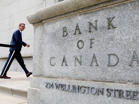 Bank of Canada Governor Tiff Macklem walks outside the Bank of Canada building in Ottawa.