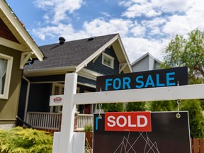 A real estate 'for sale' sign outside a home in Calgary.