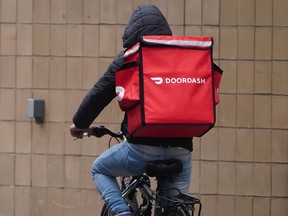 A delivery person for DoorDash rides his bike in the Manhattan borough of New York City.