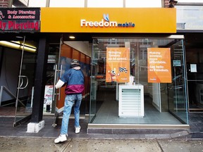 A man enters a Freedom Mobile store in Toronto.