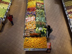 Shoppers browse produce at a Loblaws grocery store in Toronto.