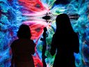 Visitors in front of an immersive art installation that will be converted into NFTs and auctioned online at Sotheby's, at the Digital Art Fair, in Hong Kong, China.