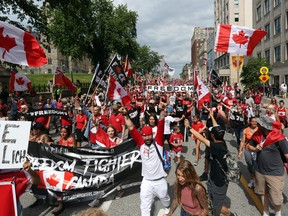 Hundreds of 'Freedom Convoy' supporters marched in downtown Ottawa on Canada Day.
