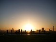 People watch the sunrise from the top of Primrose Hill in London, Britain.