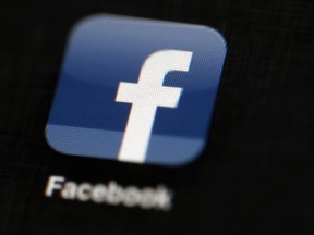 FILE - The Facebook logo is displayed on an iPad in Philadelphia, May 16, 2012. Facebook parent Meta Platforms Inc. said Tuesday, Dec. 6, 2022, it will be "forced to consider" removing news content from its platform if Congress passes legislation requiring tech companies to pay news outlets for their material.