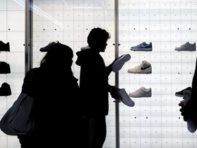 FILE - People shop for shoes in a Nike store on , Nov. 25, 2022, in New York. "Buy now, pay later" services like Affirm, Afterpay and Klarna can sometimes provide a cheaper, more accessible version of credit. These services essentially provide customers an alternative way to pay for purchases over time without going into credit card debt or taking out a traditional personal loan. Travel purchases, such as airfare and vacation rentals, are the fastest-growing segment for buy now, pay later services. However, the Consumer Financial Protection Bureau warns that usage can come at an even greater cost. These services typically entail late fees and can lead travelers to spend more than they otherwise would.