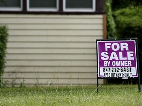 A sign is displayed in front of a home for sale in Prospect Heights, Ill., Thursday, July 10, 2022. Mortgage company Freddie Mac releases weekly mortgage rates on Friday, Dec. 15.