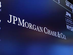 FILE - In this Aug. 16, 2019, file photo, the logo for JPMorgan Chase & Co. appears above a trading post on the floor of the New York Stock Exchange in New York. Deutsche Bank and JPMorgan Chase are asking a federal court to throw out lawsuits that claim they helped Jeffrey Epstein abuse young women and maintain his sex-trafficking ring. The banks argue they provided routine services to Epstein, and the lawsuits fail to show that they were part of Epstein's criminal sex trafficking ring.
