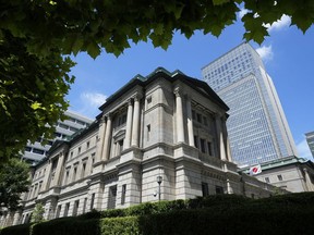 FILE - A Japanese flag flutters at the Bank of Japan headquarters in Tokyo on July 29, 2022. The Bank of Japan broadened restrictions on movement in its government bond yields, a surprise move that pushed bond yields higher globally and dinged Asian stocks.
