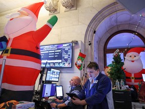 Traders work on the trading floor at the New York Stock Exchange as Christmas approaches.