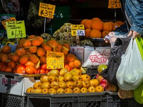 A person shops for produce at a market in Toronto.